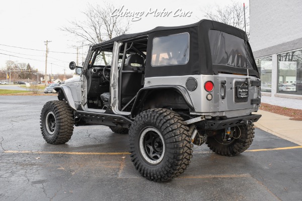 https://www.chicagomotorcars.com/imagetag/7607/8/f/Used-2013-Jeep-Wrangler-Unlimited-Rubicon-4X4-Metallic-Clear-Coat-Exterior-over-Black-Leather-Interior-A-TRUE-ROCK-CRAWLE.jpg