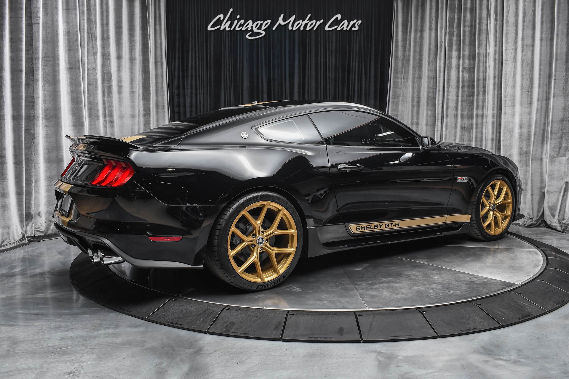 black mustang gold rims